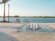 Scenic waterfront path with a fountain and couple on bikes at 23210 Banbury Way # 101, Venice, FL 34293