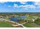 Aerial view of community with golf course and lake at 23402 Copperleaf Dr, Venice, FL 34293