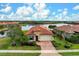 Aerial view of a single-Gathering home with a pool and lake view in a residential community at 23402 Copperleaf Dr, Venice, FL 34293