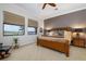 Main bedroom with king-size bed, lake view, and ample natural light at 23402 Copperleaf Dr, Venice, FL 34293