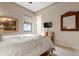 Serene bedroom with bamboo bed frame and neutral color palette at 23402 Copperleaf Dr, Venice, FL 34293