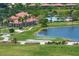 Community clubhouse with pool and palm trees at 23402 Copperleaf Dr, Venice, FL 34293