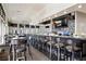 Modern clubhouse bar with comfortable seating and large screen TV at 23402 Copperleaf Dr, Venice, FL 34293