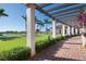 A walkway with pergola and palm trees leads to clubhouse at 23402 Copperleaf Dr, Venice, FL 34293
