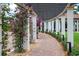 Walkway under pergola with bougainvillea and landscaping at 23402 Copperleaf Dr, Venice, FL 34293