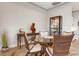 Bright dining room features glass table and wicker chairs at 23402 Copperleaf Dr, Venice, FL 34293