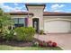 Inviting home exterior with brick driveway and nicely landscaped front yard at 23402 Copperleaf Dr, Venice, FL 34293