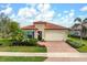 Single-Gathering home with brick driveway and landscaping at 23402 Copperleaf Dr, Venice, FL 34293