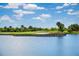 Landscaped golf course with pond and blue sky at 23402 Copperleaf Dr, Venice, FL 34293