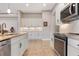 Spacious kitchen featuring stainless steel appliances and white cabinets at 23402 Copperleaf Dr, Venice, FL 34293