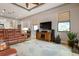 Comfortable living room featuring leather furniture and large TV at 23402 Copperleaf Dr, Venice, FL 34293