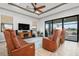 Relaxing living room with leather furniture and sliding doors to pool area at 23402 Copperleaf Dr, Venice, FL 34293