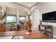 Home office featuring large windows, wood desk, and mounted wildlife at 23402 Copperleaf Dr, Venice, FL 34293