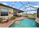 Inviting pool and spa with covered patio and outdoor dining area at 23402 Copperleaf Dr, Venice, FL 34293