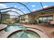Beautiful pool and spa with covered patio and lounge chairs at 23402 Copperleaf Dr, Venice, FL 34293