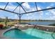 Stunning pool and spa with lake view, screened enclosure, and hot tub at 23402 Copperleaf Dr, Venice, FL 34293