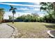 Spacious backyard with grassy area and palm trees at 237 San Marco Dr, Venice, FL 34285