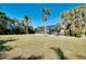Spacious backyard with screened enclosure, lush landscaping, and patio seating at 237 San Marco Dr, Venice, FL 34285