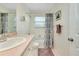 Bathroom with tub, shower, and updated vanity at 237 San Marco Dr, Venice, FL 34285