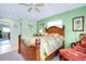 Bedroom with wood bed frame, tropical bedding, and sitting area at 237 San Marco Dr, Venice, FL 34285