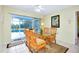 Casual dining area with glass-top table and chairs, providing pool access at 237 San Marco Dr, Venice, FL 34285