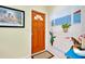 Inviting entryway with a unique mural and a wooden door at 237 San Marco Dr, Venice, FL 34285