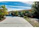 Tan single story home with circular driveway, landscaping, and attached garage at 237 San Marco Dr, Venice, FL 34285