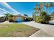 Single-story home with a white garage door, landscaping, and a long driveway at 237 San Marco Dr, Venice, FL 34285