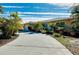 Single-story home with a curving driveway and lush tropical landscaping at 237 San Marco Dr, Venice, FL 34285