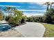 Curved driveway leading to a charming house with lush landscaping at 237 San Marco Dr, Venice, FL 34285