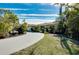 Curved driveway leading to a charming house with lush landscaping at 237 San Marco Dr, Venice, FL 34285