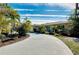 Curved driveway leading to a charming house with lush landscaping at 237 San Marco Dr, Venice, FL 34285