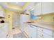 Well-equipped kitchen with white cabinets and tile floors at 237 San Marco Dr, Venice, FL 34285