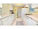 Efficient kitchen with white cabinetry, ample counter space, and modern appliances at 237 San Marco Dr, Venice, FL 34285