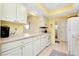 Modern kitchen with white cabinetry and new appliances at 237 San Marco Dr, Venice, FL 34285