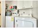 Laundry room with washer, dryer, and overhead cabinets at 237 San Marco Dr, Venice, FL 34285