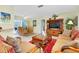 Bright living room features comfortable seating, a large TV, and a view into the dining area at 237 San Marco Dr, Venice, FL 34285