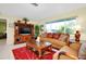 Cozy living room with wood furniture and a red rug at 237 San Marco Dr, Venice, FL 34285
