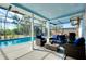 Enclosed patio with seating overlooking refreshing pool at 237 San Marco Dr, Venice, FL 34285
