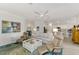 Light and airy living room with ample seating and views into the kitchen at 24165 Spartina Dr, Venice, FL 34293