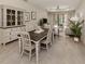 Farmhouse style dining room with wooden table and neutral color scheme at 244 Livorno Way, Nokomis, FL 34275