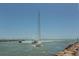 Two sailboats passing through a channel near a rocky shoreline at 244 Livorno Way, Nokomis, FL 34275