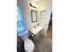 Bathroom with toilet, sink, and mirrored vanity at 28 Castaway Ct, North Port, FL 34287