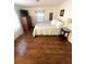 Bedroom with queen bed, dresser and wood-look floors at 28 Castaway Ct, North Port, FL 34287