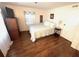 Bedroom with a queen bed, dresser, and wood-look flooring at 28 Castaway Ct, North Port, FL 34287
