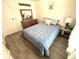 Comfortable bedroom with a dresser and a blue bedspread at 28 Castaway Ct, North Port, FL 34287