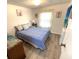 Charming bedroom with a blue bedspread and coastal decor at 28 Castaway Ct, North Port, FL 34287