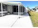 Side view of a mobile home with a covered carport and paved area at 28 Castaway Ct, North Port, FL 34287