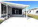 Covered carport with screened enclosure and paved area at 28 Castaway Ct, North Port, FL 34287