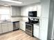 Modern kitchen with stainless steel appliances and granite countertops at 28 Castaway Ct, North Port, FL 34287